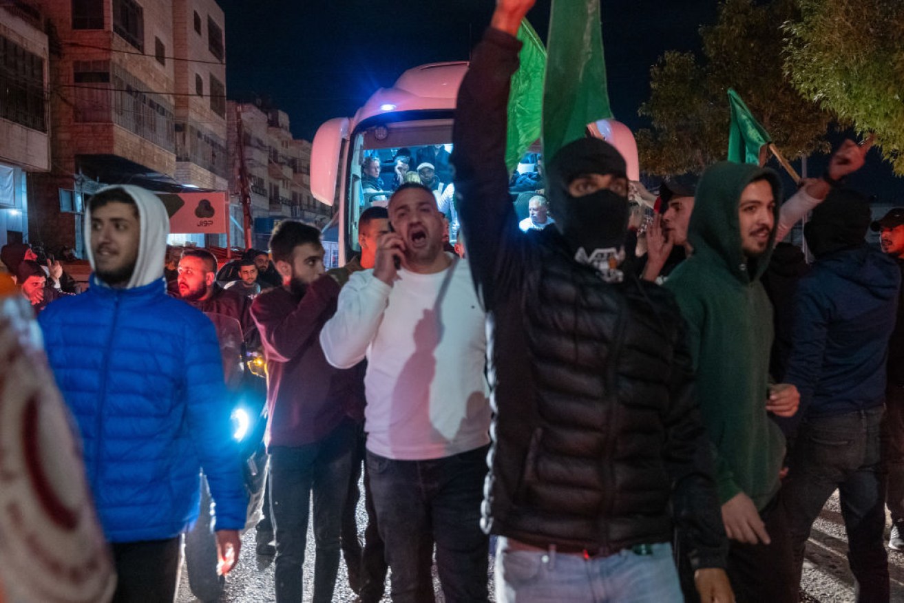 A bus carrying 30 freed Palestinian prisoners makes its way into the centre of Ramallah after they were released on November 30.