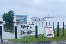 Floodwaters threaten to cut off second coastal town