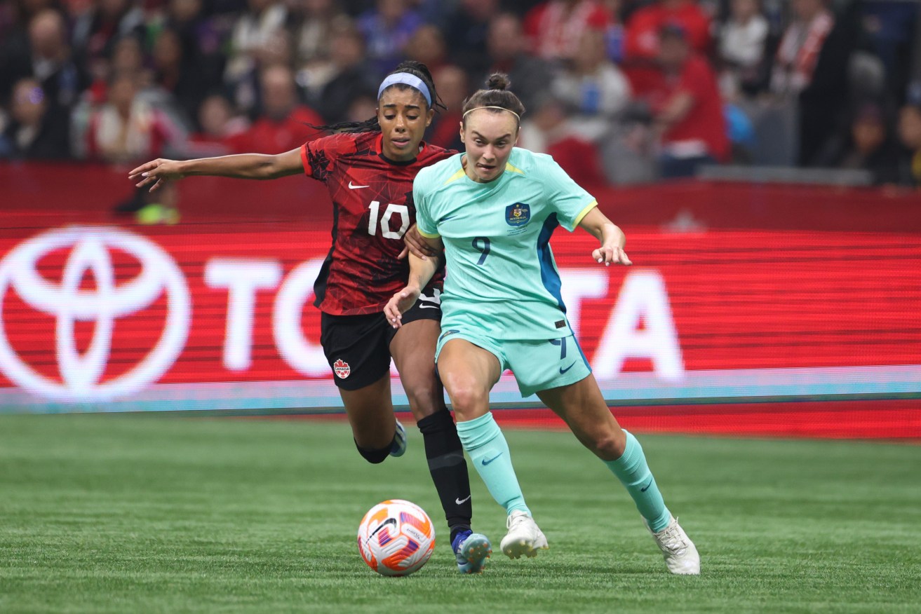 Caitlin Foord shields the ball from Canada’s Ashley Lawrence in Vancouver on Wednesday.