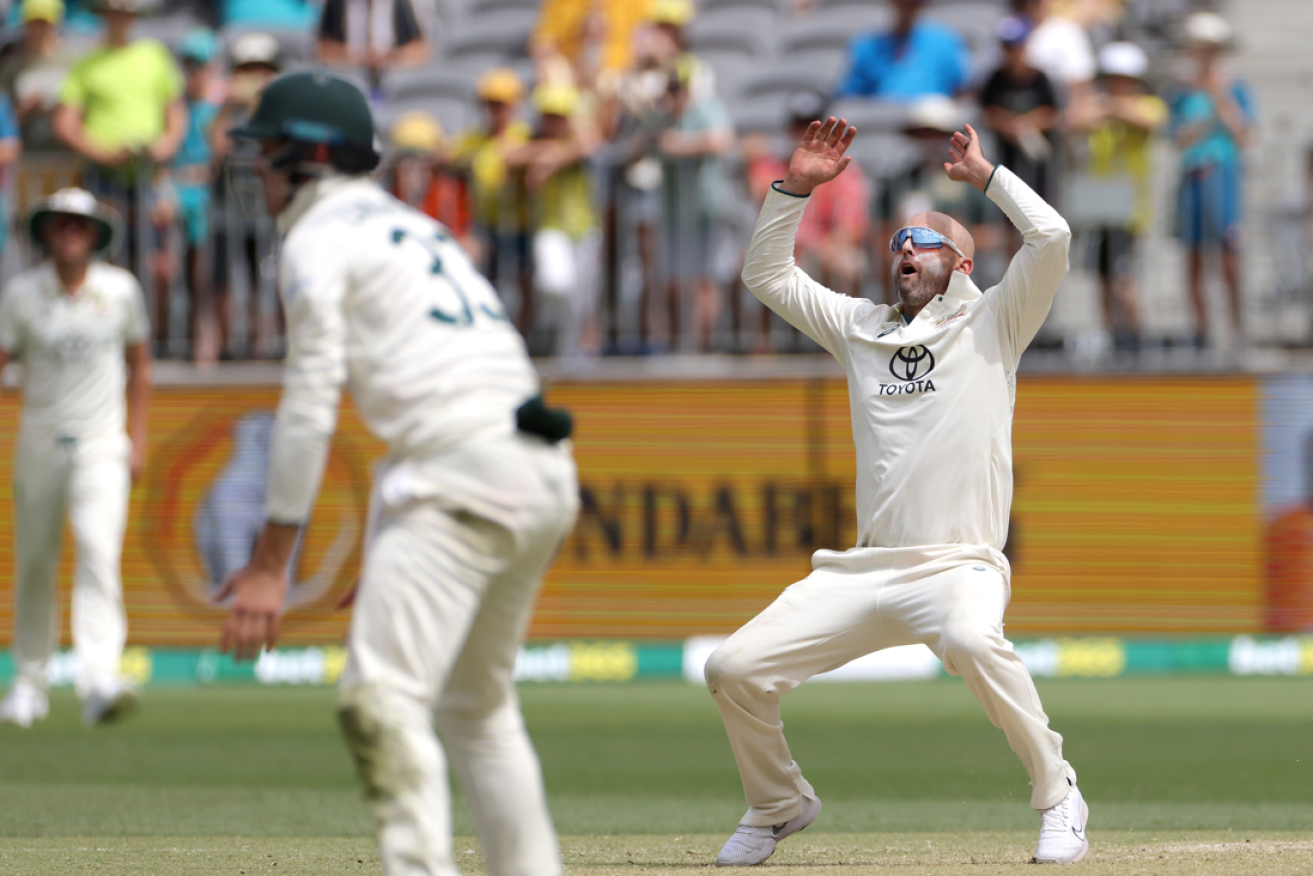 Nathan Lyon reacts after lifting his career wicket tally to 499.