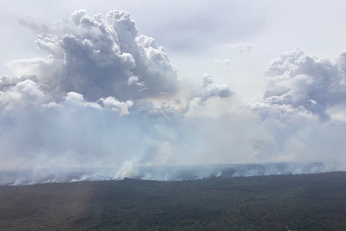 NSW crews have controlled some pockets of a huge bushfire that has created its own weather system.