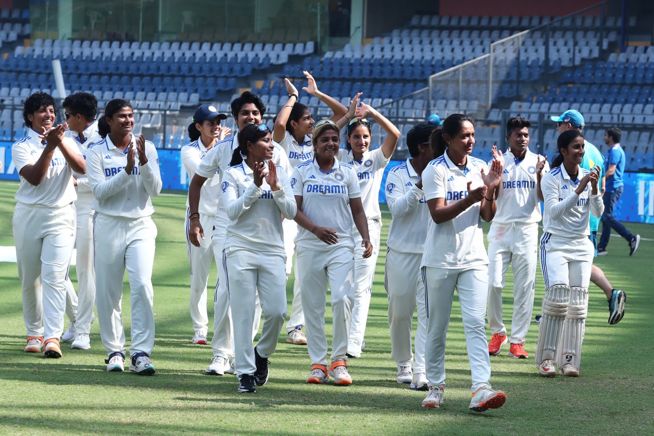 Indian players celebrate their team's win over Australia on day four of the women's Test match at Wankhede Stadium on Sunday in Mumbai. 
