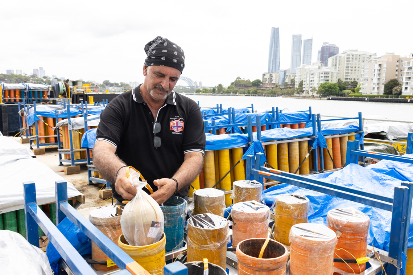 A pyrotechnician places another pod in preparation for Sydney's eye-popping New Year celebration.