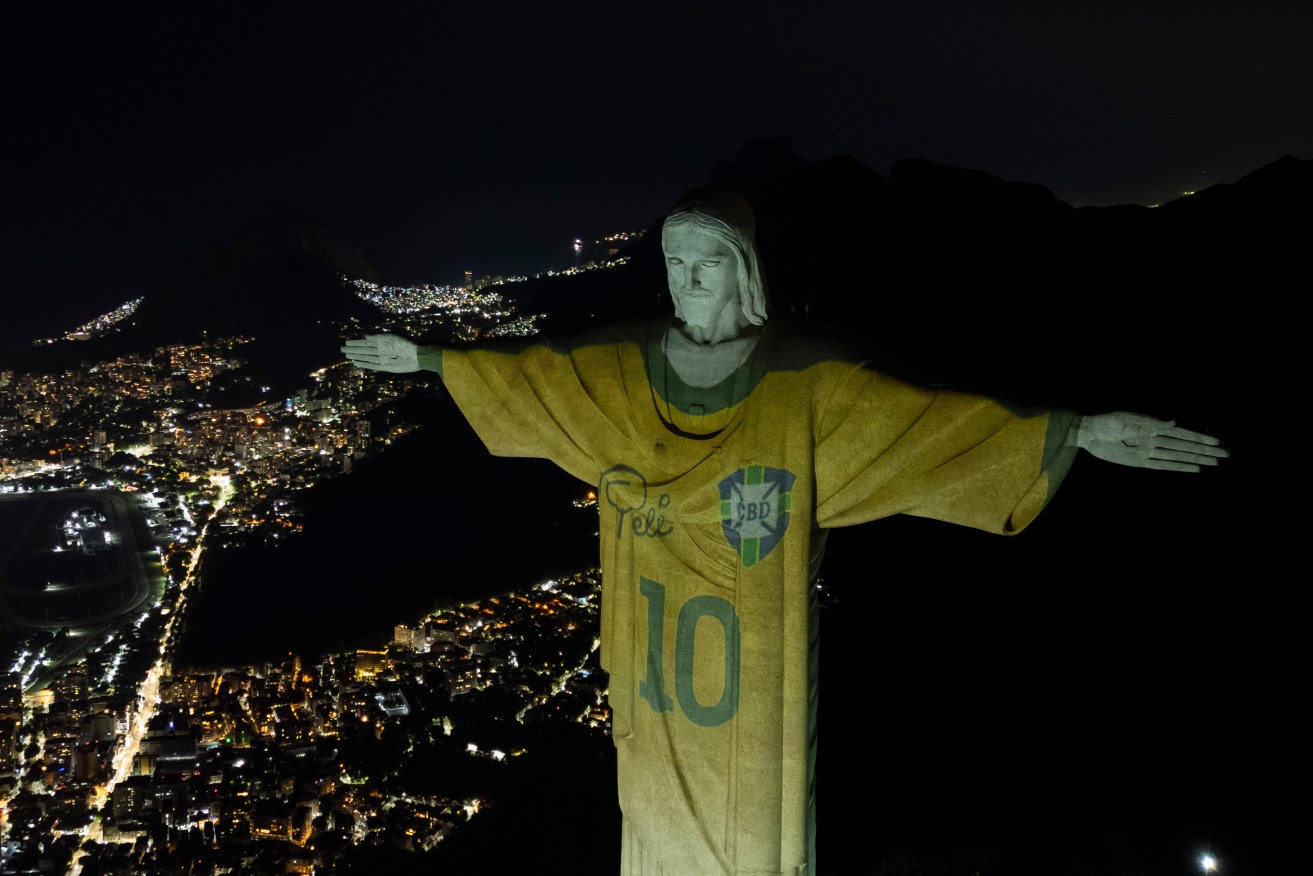 Christ the Redeemer illuminated with Pele's Brazil shirt on the first anniversary of his death.