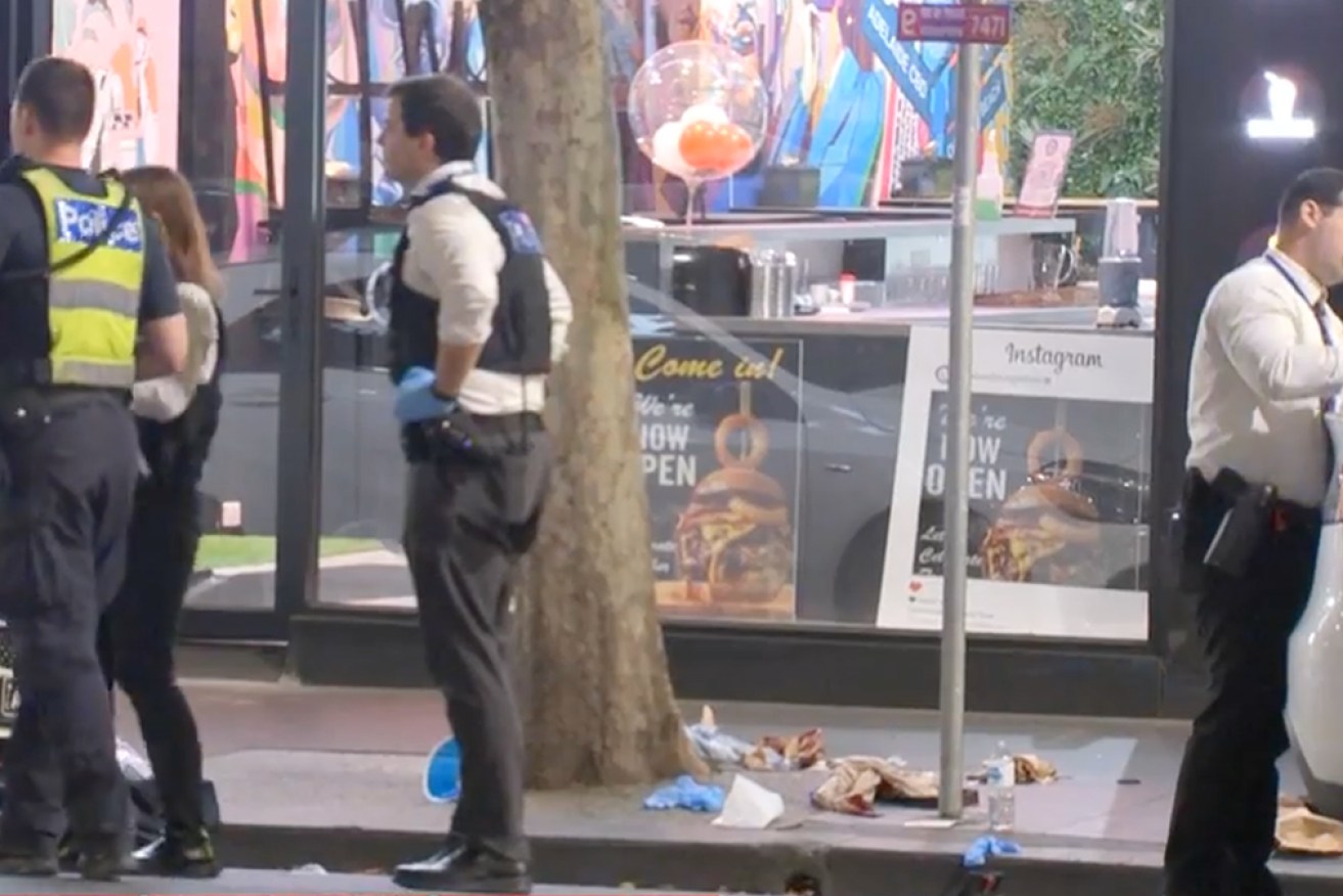 Police examine the scene of one of the stabbing attacks in Melbourne.