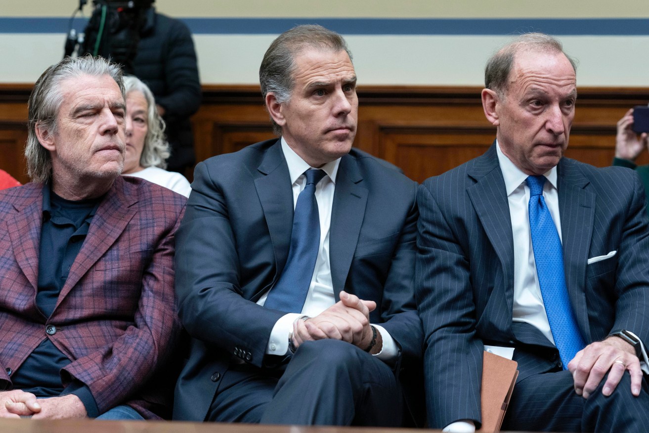 Hunter Biden (centre) was scolded by lawmakers for his surprise attendance.