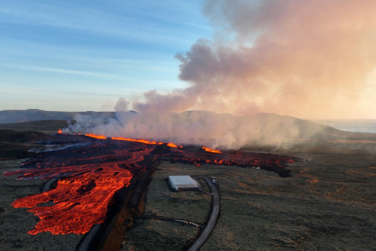 Lava and smoke billows over the landscape near the south-western town of Grindavik on Sunday. 