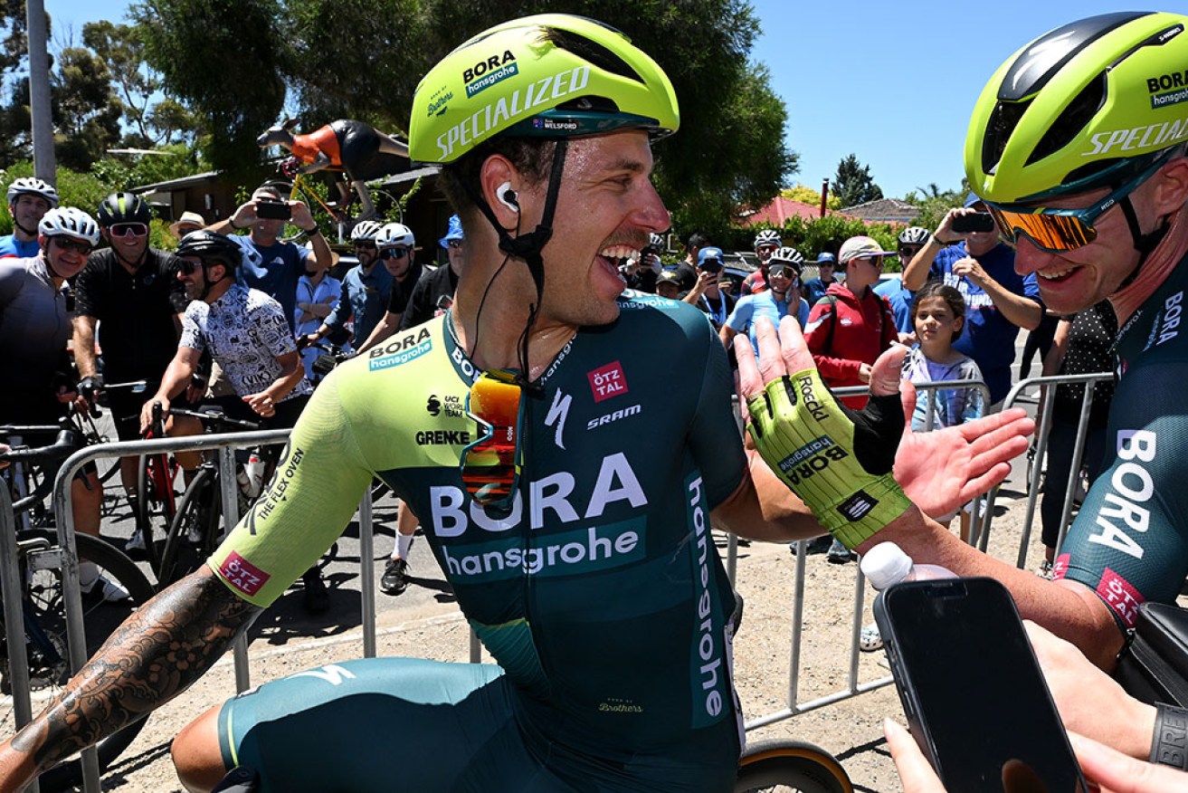 Stage winner Sam Welsford is congratulated by teammate Ryan Mullen at the Tour Down Under on Thursday. 