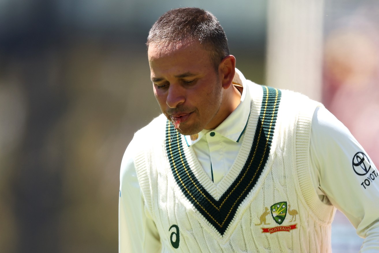 Usman Khawaja spits blood after being struck on the helmet in Australia's first Test victory.