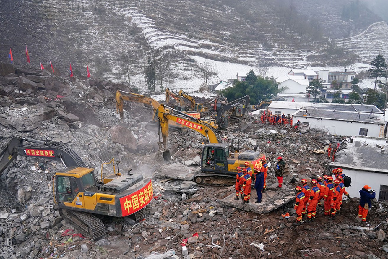 Rescue workers search for missing victims at a landslide site, a day after it hit Liangshui village in Zhaotong, in southwestern China's Yunnan province. 