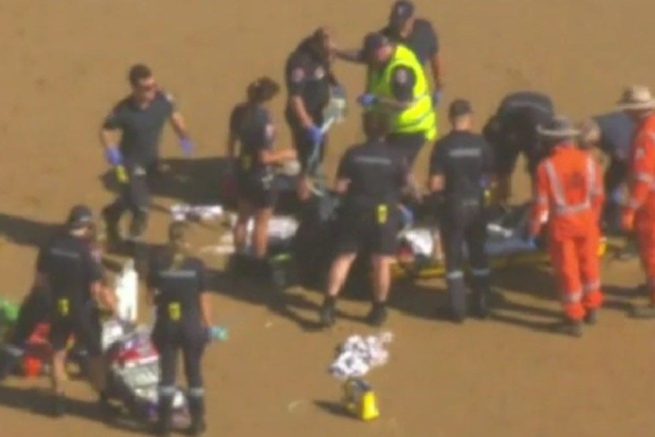 Paramedics attempt to revive the victims.