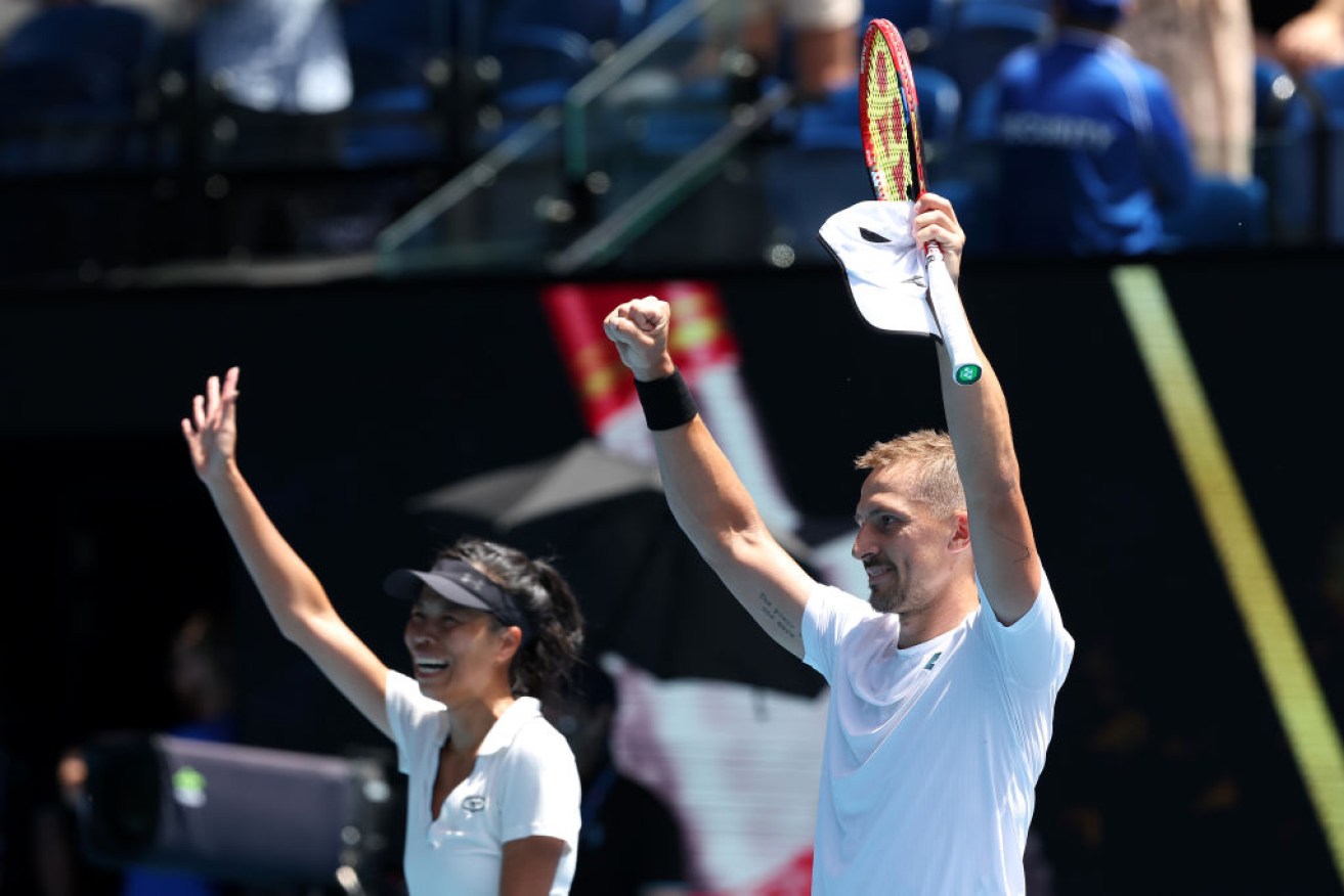Hsieh Su-wei of Taiwan and Jan Zielinski of Poland celebrate winning championship point in their mixed doubles final at Melbourne Park.
