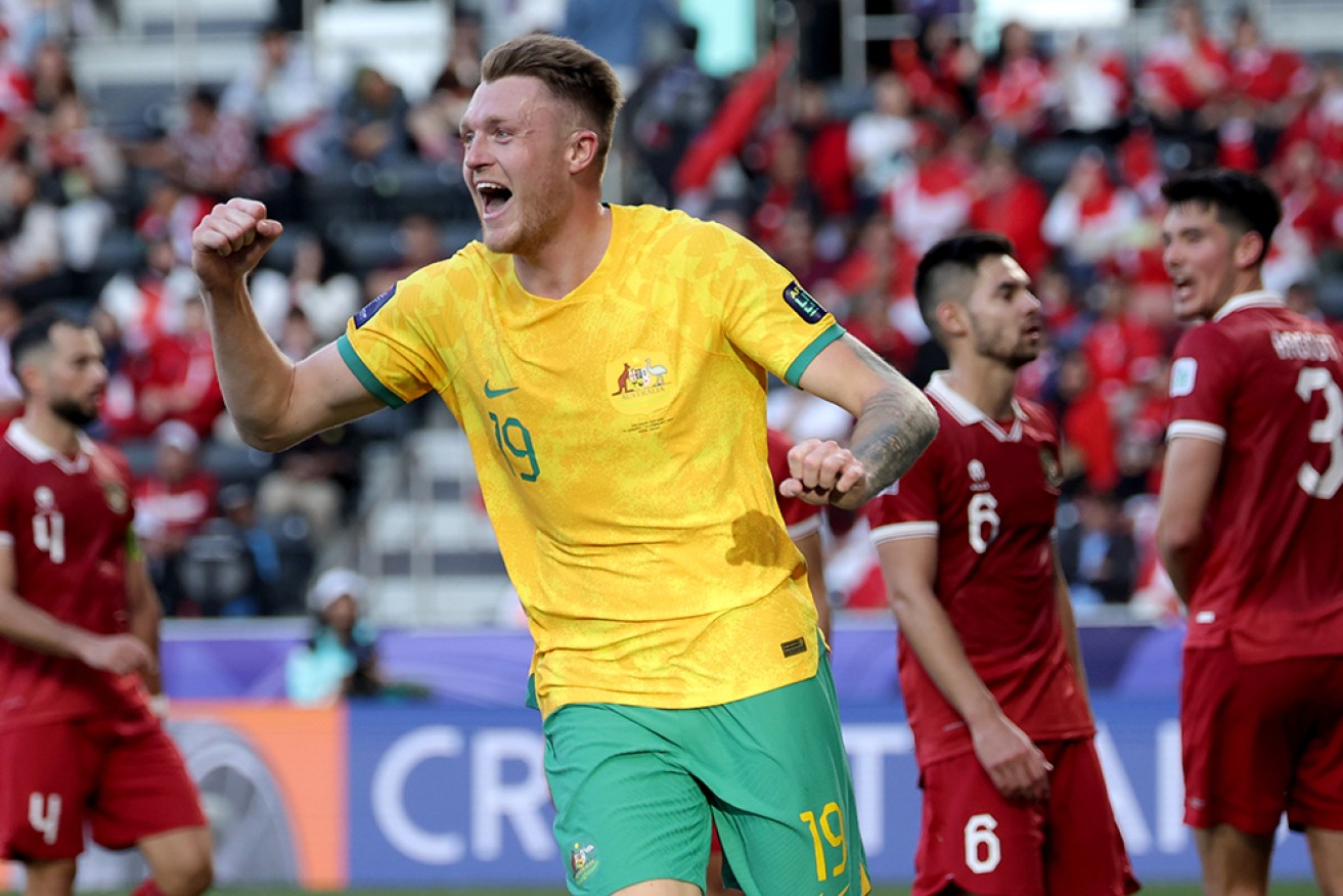 Australia’s Harry Souttar enjoys his late headed goal after a centimetre-perfect cross from Craig Goodwin in Doha. 