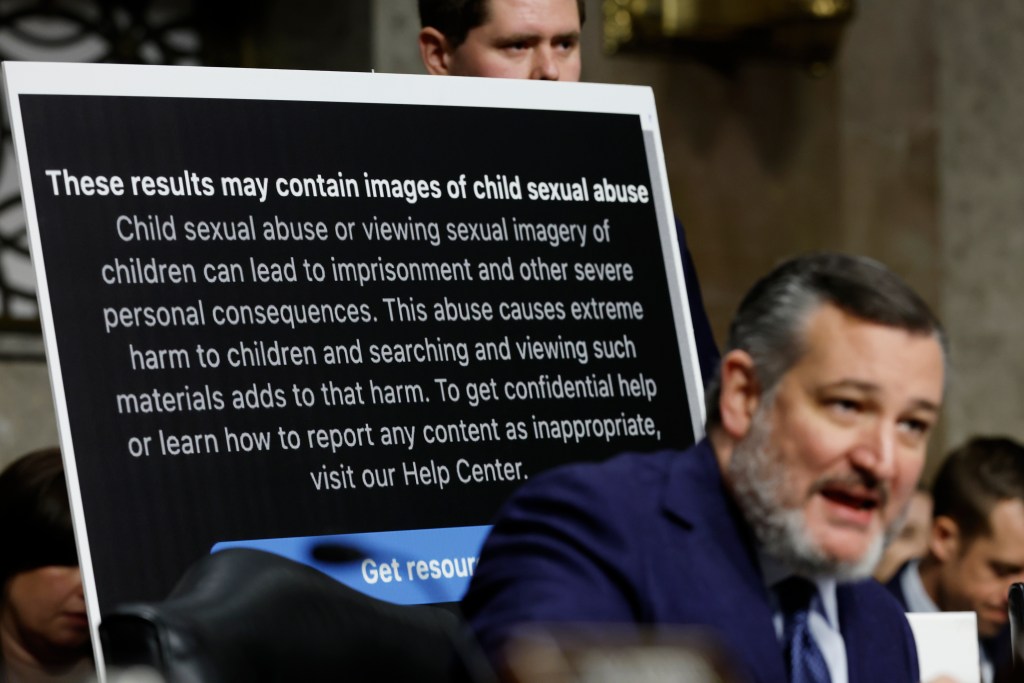An aide holds up a poster as Sen. Ted Cruz (R-TX) speaks during a Senate Judiciary Committee hearing at the Dirksen Senate Office Building on January 31, 2024 in Washington, DC. The committee heard testimony from the heads of the largest tech firms on the dangers of child sexual exploitation on social media