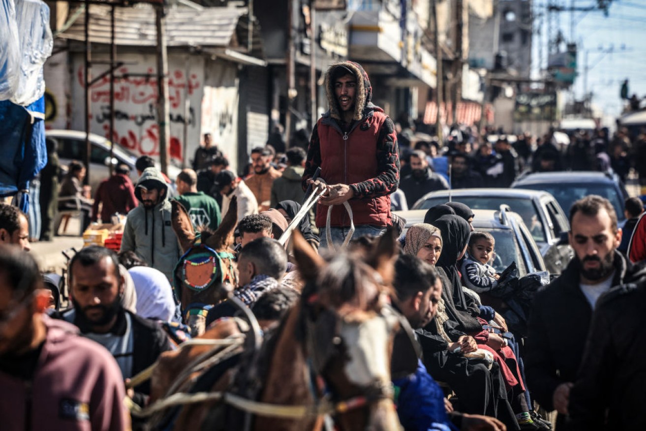 People who fled fighting in the Gaza Strip gather along an overcrowded street in Rafah on February 1. 