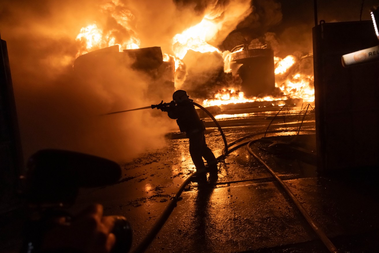 Firefighters extinguish a fire after a Russian drone attack that killed seven in Kharkiv, Ukraine.