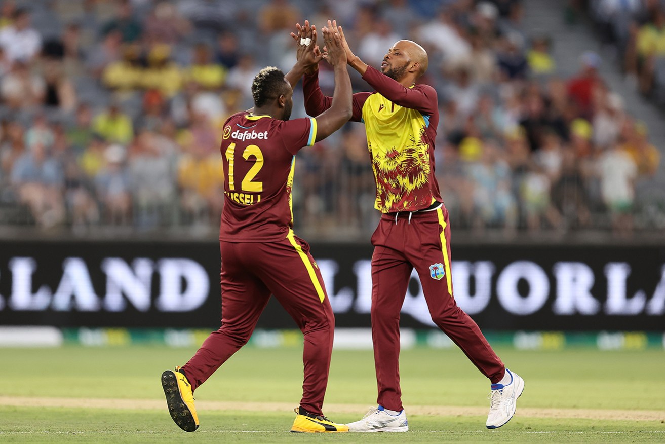 Andre Russell and Roston Chase of the West Indies celebrate a wicket in Perth on Tuesday night.