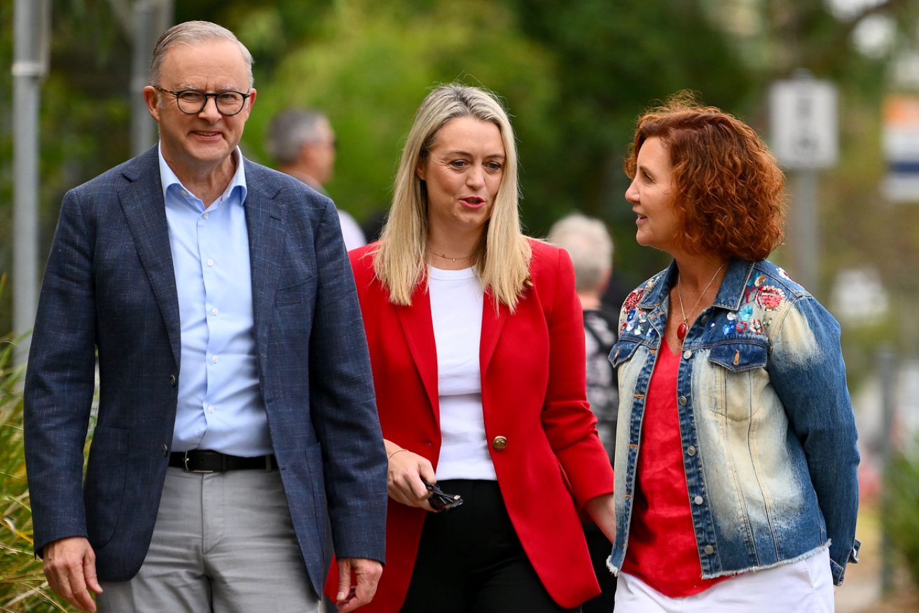 PM Anthony Albanese flashes a winning smile with partner Jodie Haydon and Labor candidate for Dunkley Jodie Belyea.