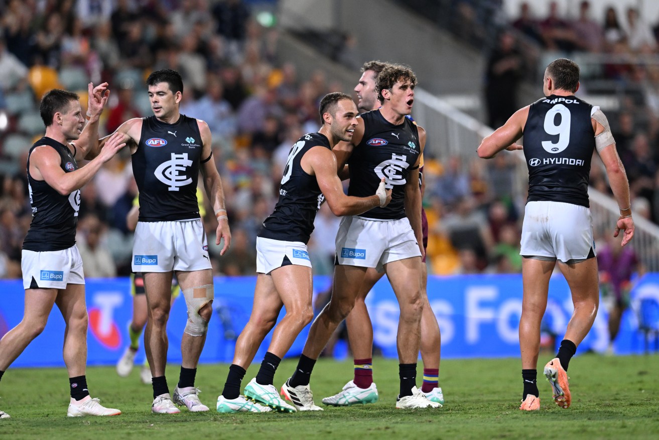 Carlton's Charlie Curnow (centre) celebrates kicking a goal during the AFL Opening Round match against the Brisbane Lions at the Gabba.