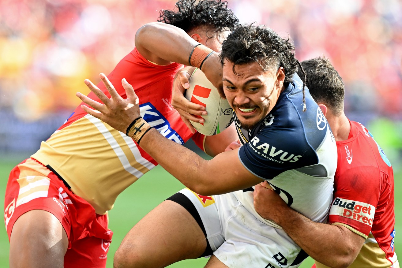North Queensland’s Jeremiah Nanai takes on the Dolphins defence at Suncorp Stadium on Sunday.