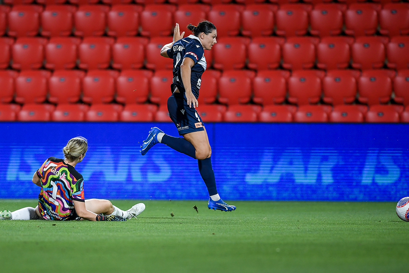 Melbourne Victory striker Emily Gielnik skips clear of Reds goalkeeper Annalee Grove at Coopers Stadium on Sunday. 