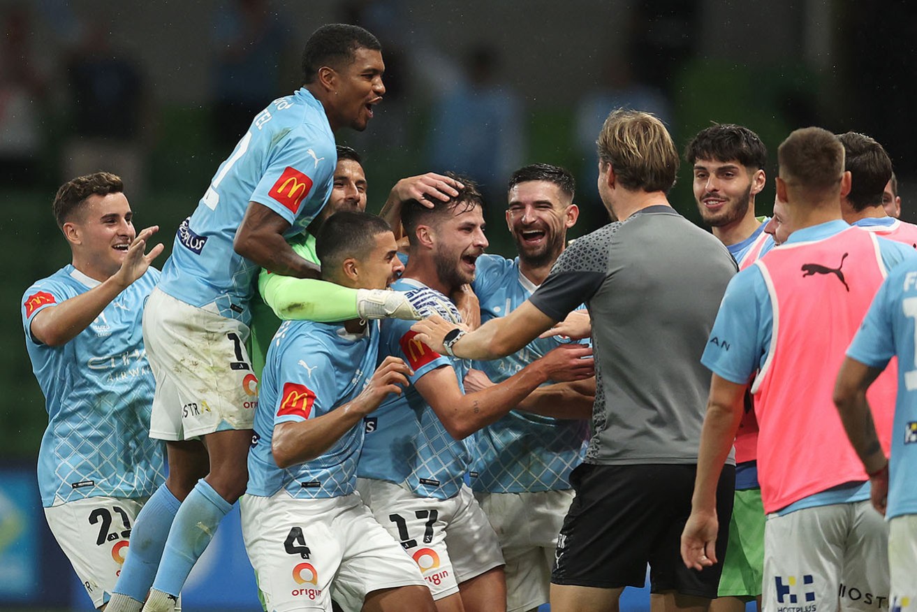 Melbourne City teammates mob Terry Antonis after his wonder strike from halfway at AAMI Park on Tuesday night.