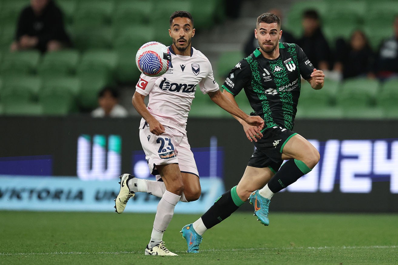 Melbourne Victory’s  Sam Khelifi tussles with Western United’s Ben Garuccio on Thursday night. 