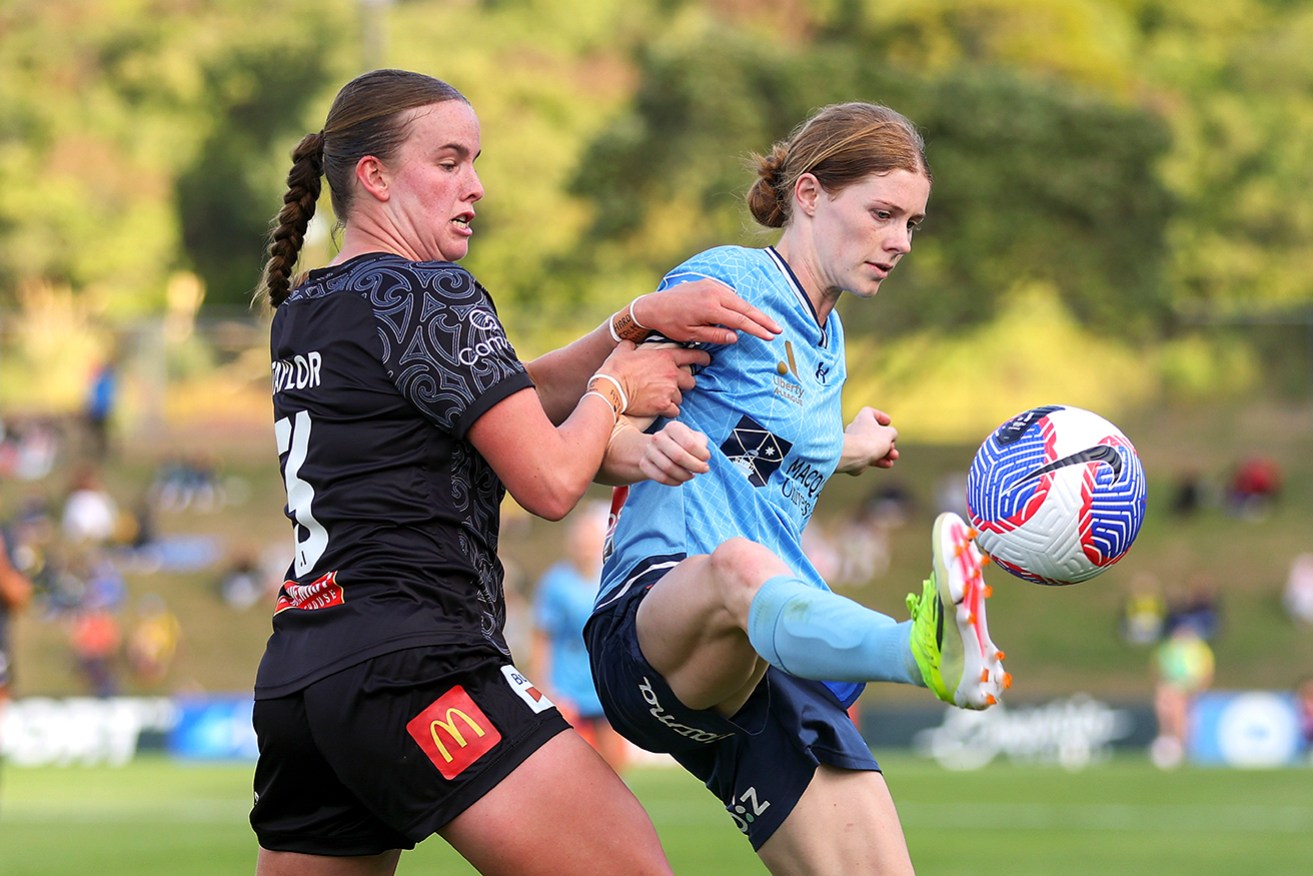 Wellington’s Kate Taylor challenges Sydney’s Cortnee Vine, who scored twice on Sunday. 