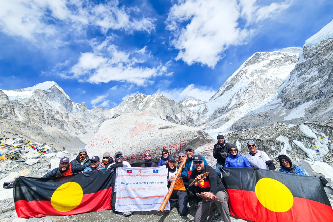 The Indigenous trekkers show the flag -- two, actually -- at Everest base camp.