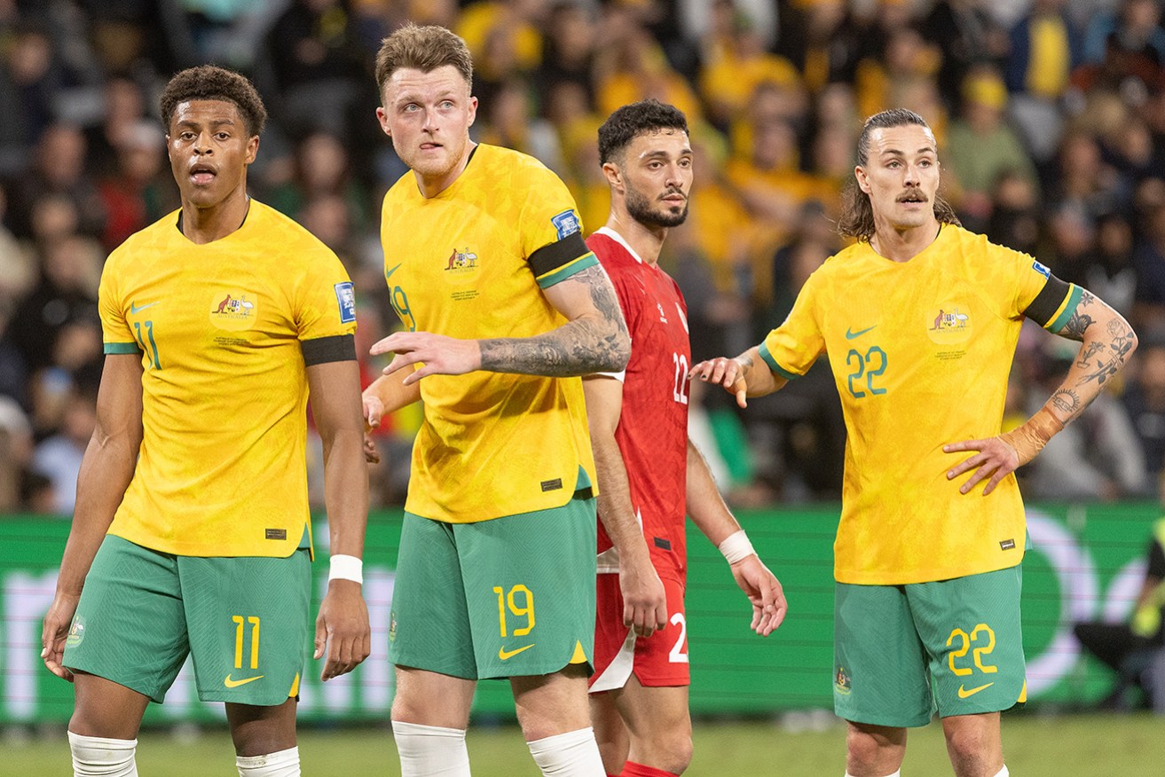 Socceroos Kusini Yengi, Harry Souttar and Jackson Irvine are defended by Lebanon's Bassel Jradi. They play again on Tuesday night in Canberra.