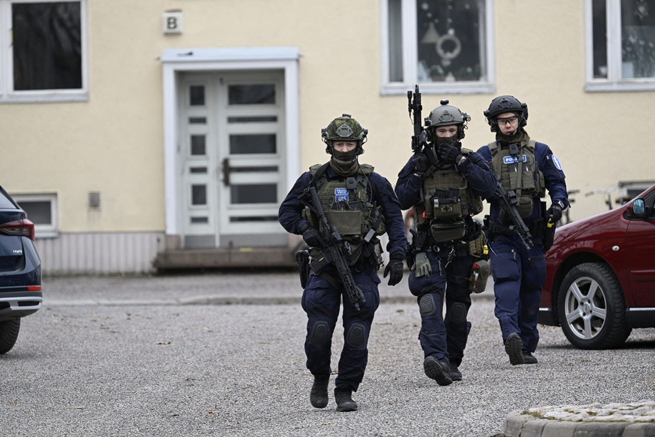 Finnish police investigate the scene at the Viertola comprehensive school where a child opened fire and injured three other children in Vantaa.