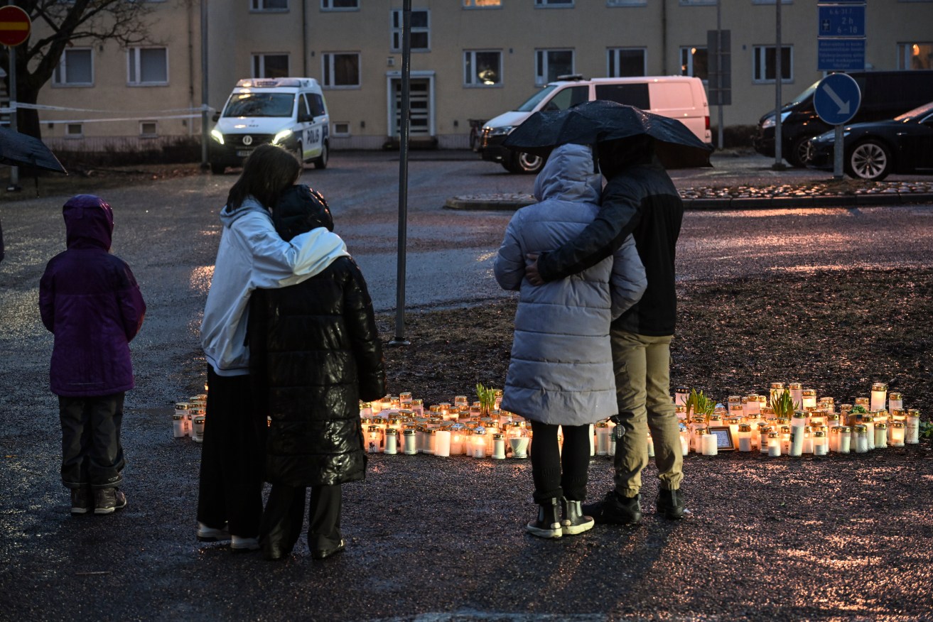  People leave candles in the school yard where a shooting incident took place