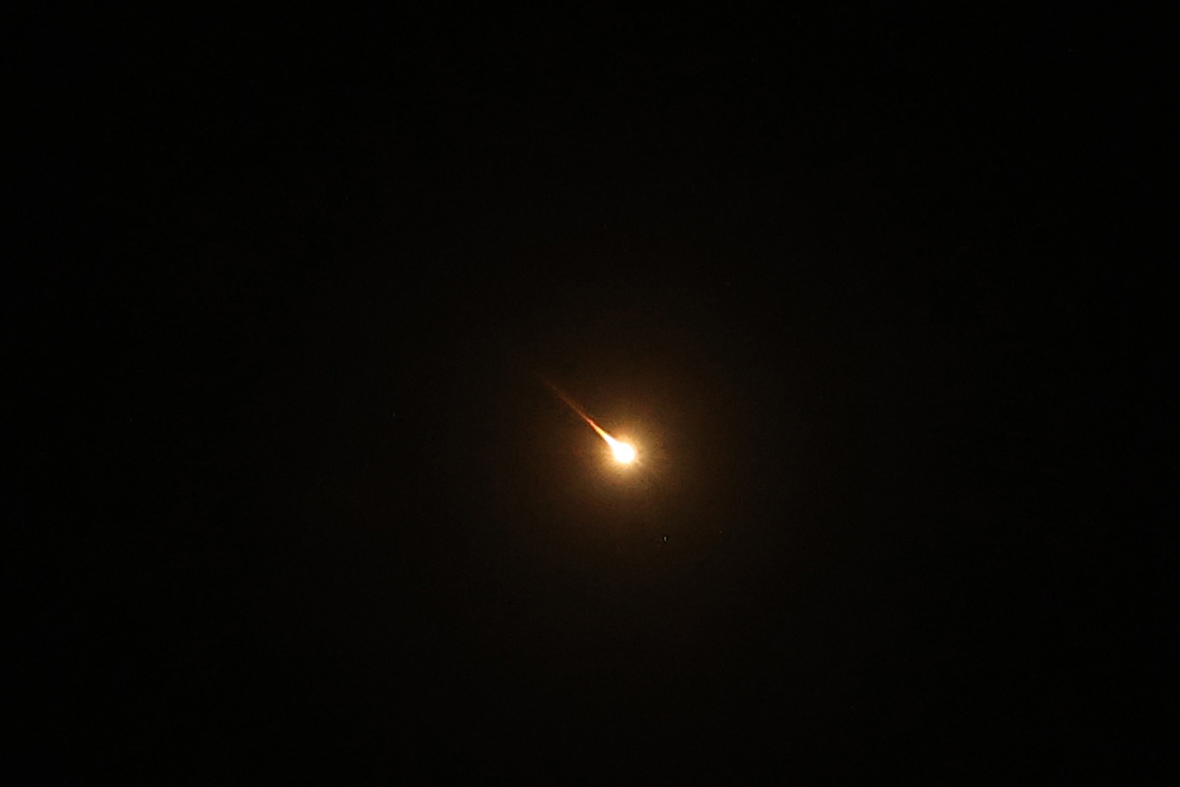 Explosions are seen in the skies over Ramallah following Iran's attack on Israel on Sunday.