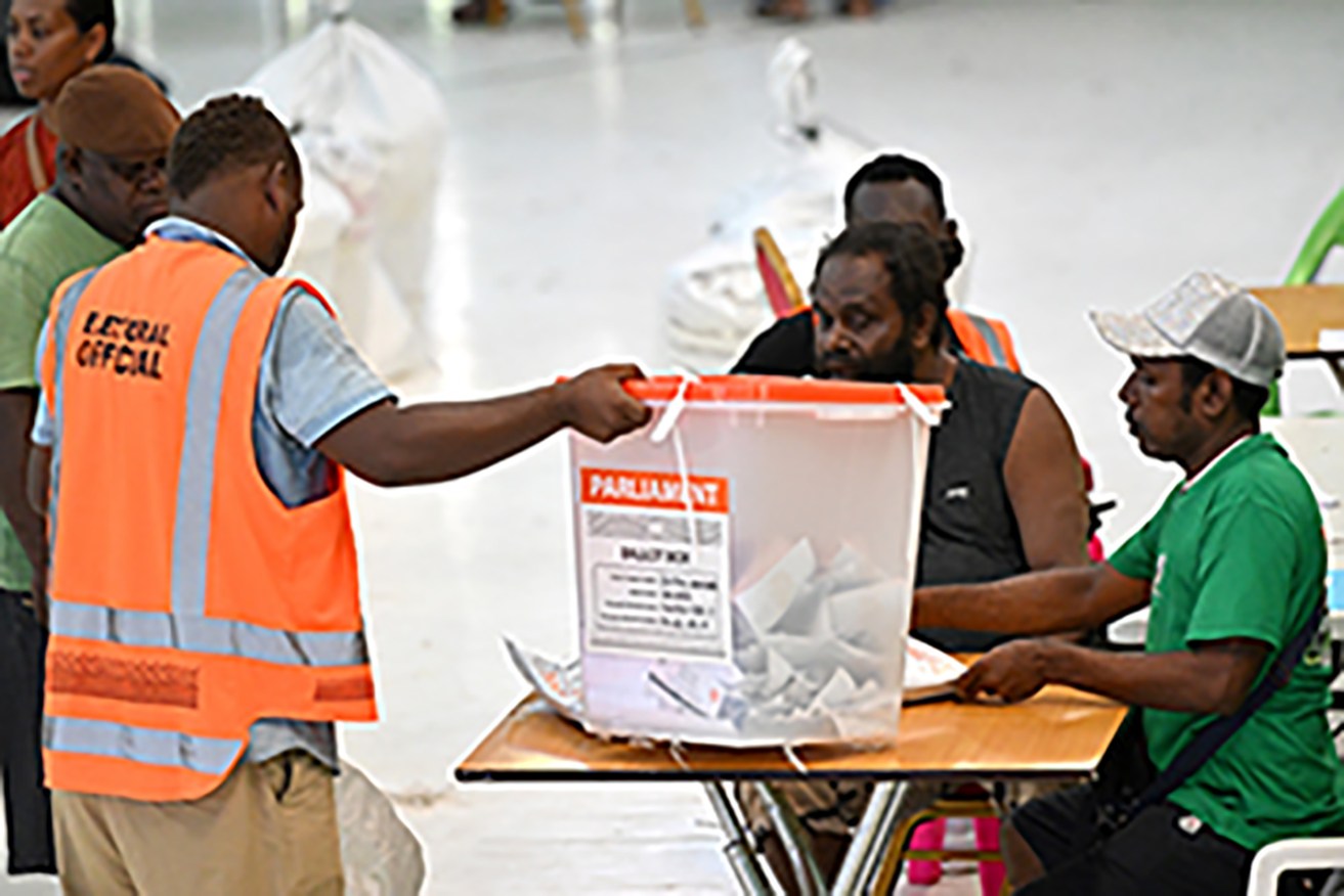 Electoral officers verify a ballot box at a vote counting centre in Honiara on Thursday.  