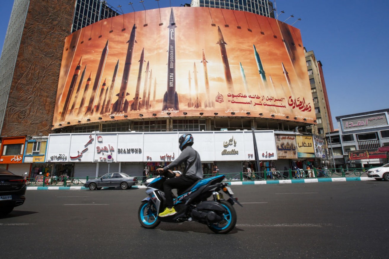 A billboard depicts Iranian ballistic missiles in service in Tehran on April 19, 2024.