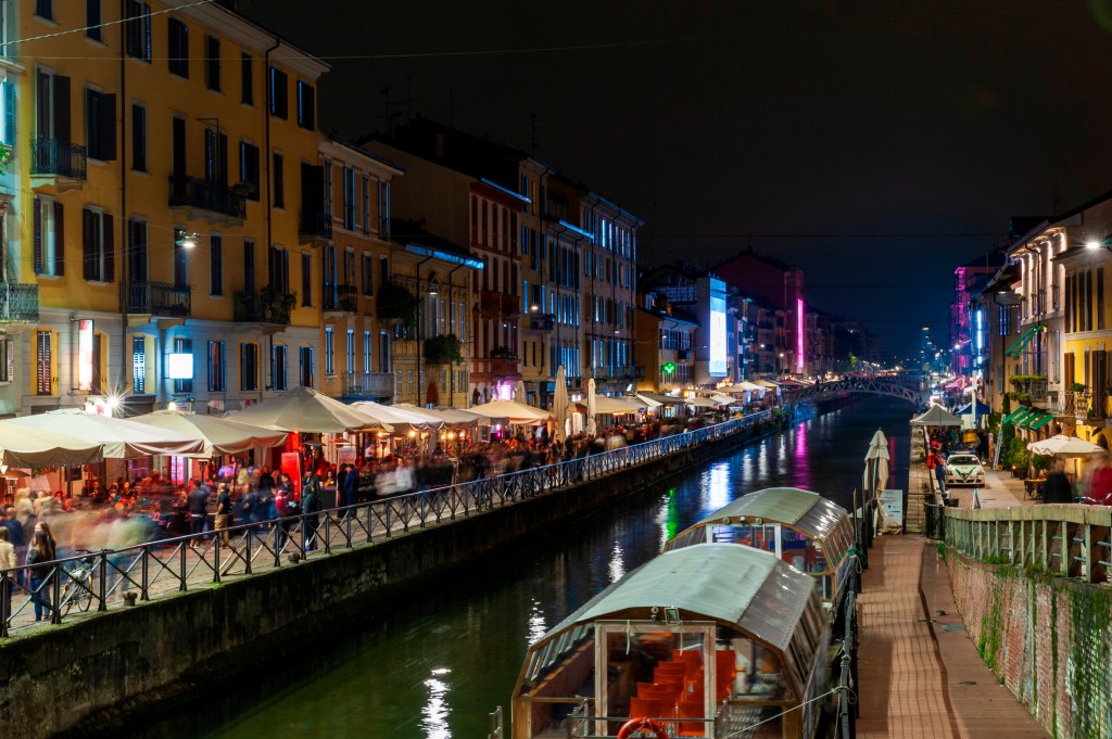 People have fun in the evening bars at Navigli District. Milan. Lombardy. Italy. Europe.