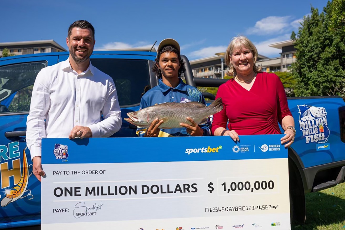 Keegan Payne holds the barramundi that netted him a $1 million prize.