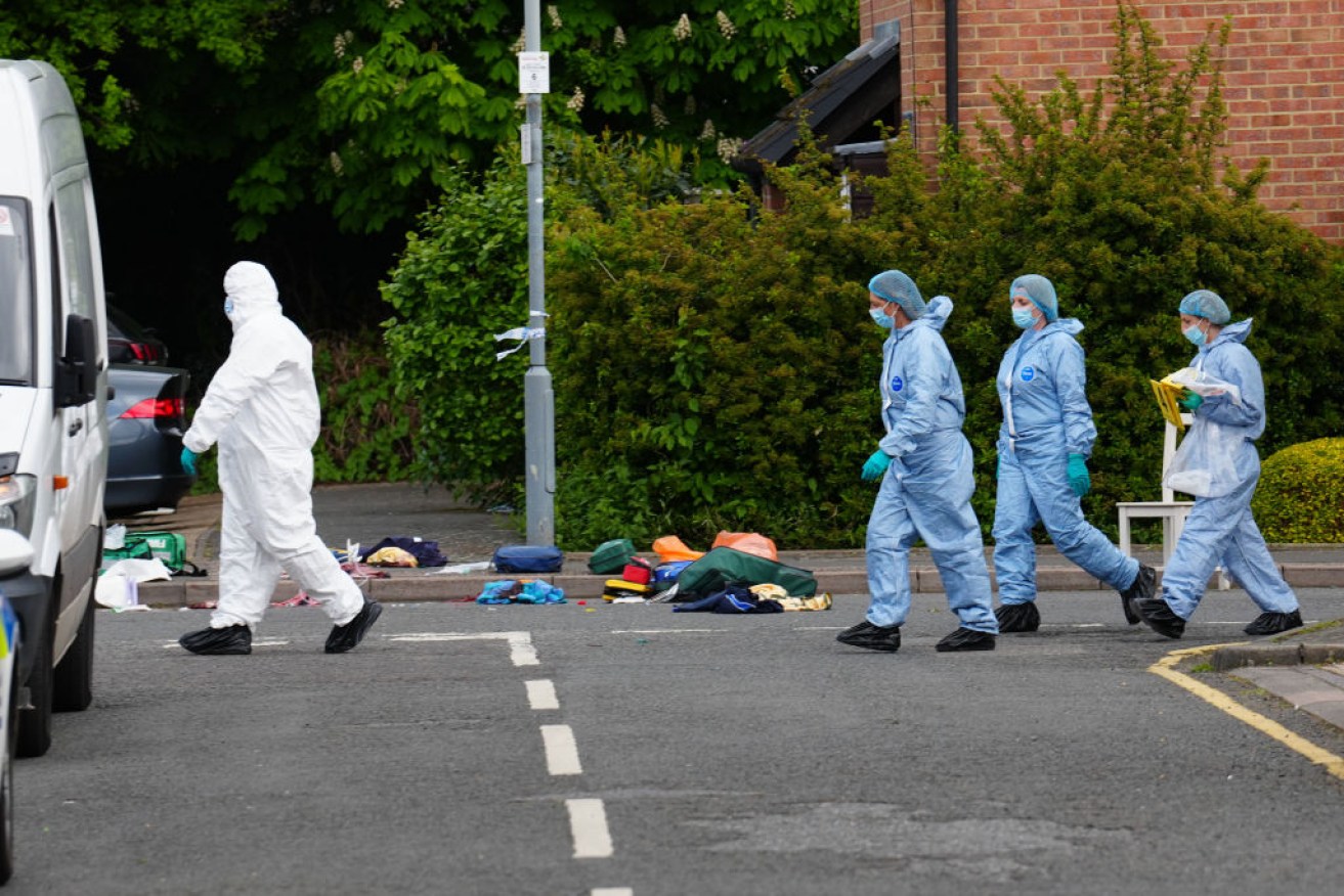 Forensic officers work the crime scene in Hainault, east London.