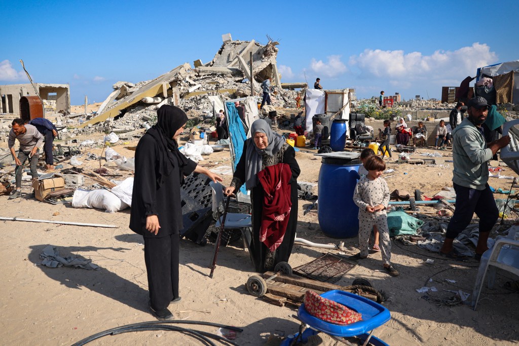 Displaced Palestinians pack their belongings before leaving an unsafe area in Rafah on May 15,