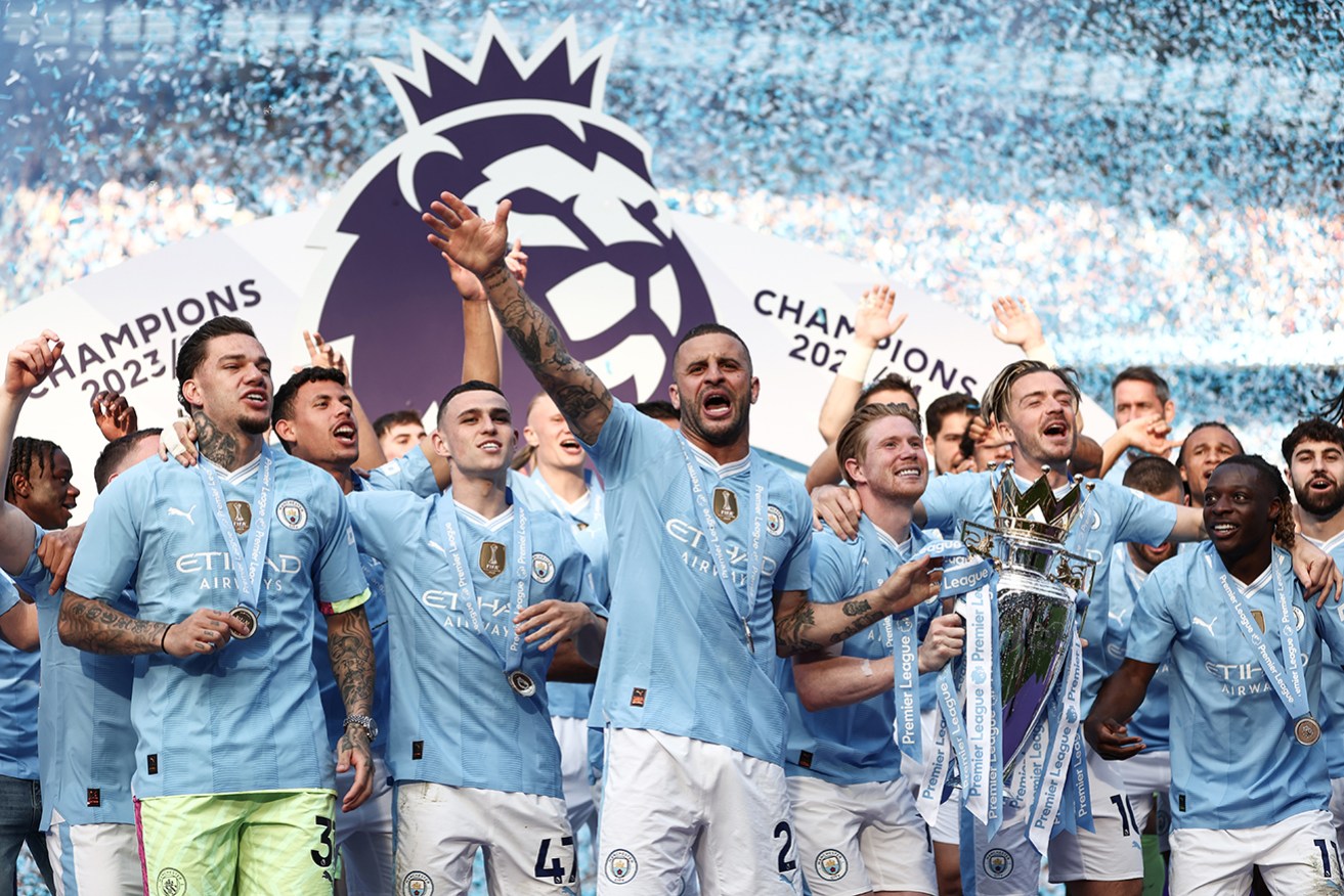 Kyle Walker lifts the Premier League trophy after Manchester City’s win over West Ham United at Etihad Stadium.