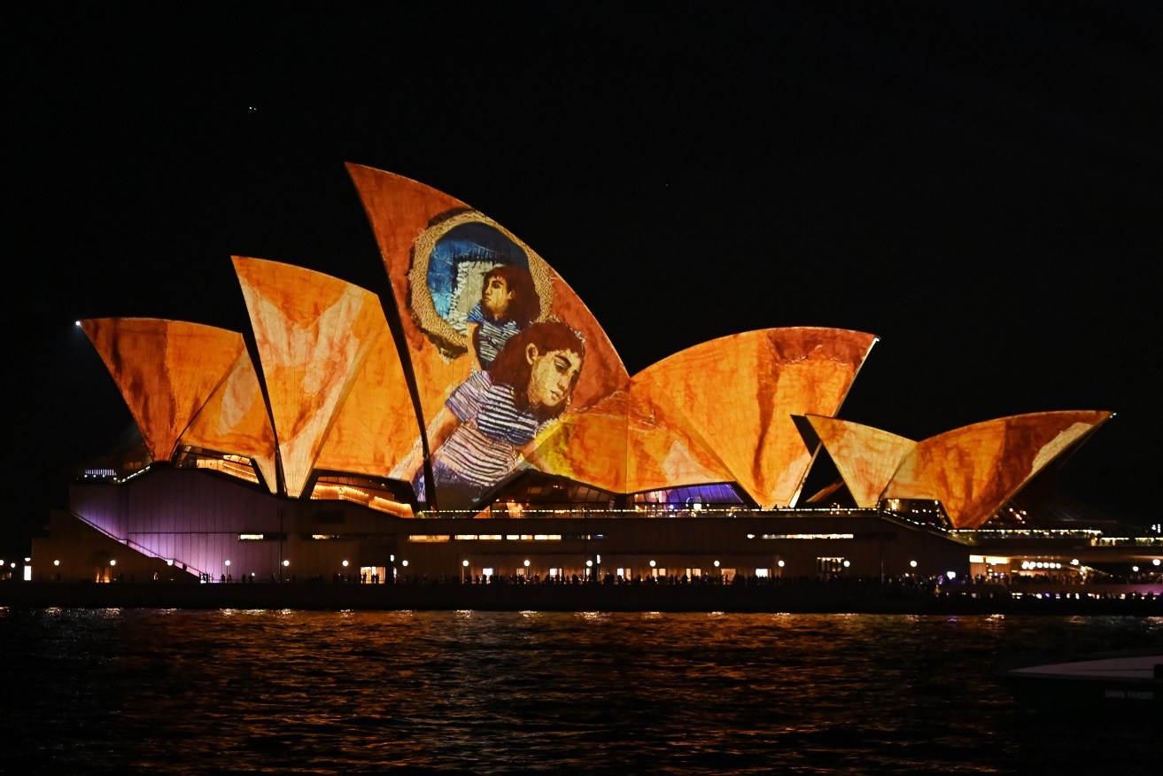 The sails of the Sydney Opera House are illuminated with projections of Julia Gutman's work.