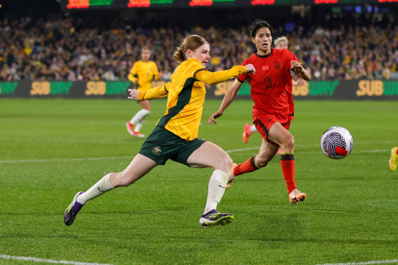 Cortnee Vine is tackled by Qiaozhu Chen of China during the Adelaide match.