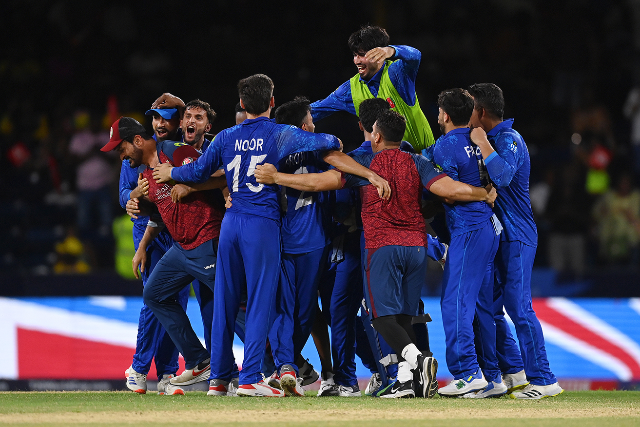 Jubilant Afghanistan players celebrate beating Australia in St Vincent on Sunday. 