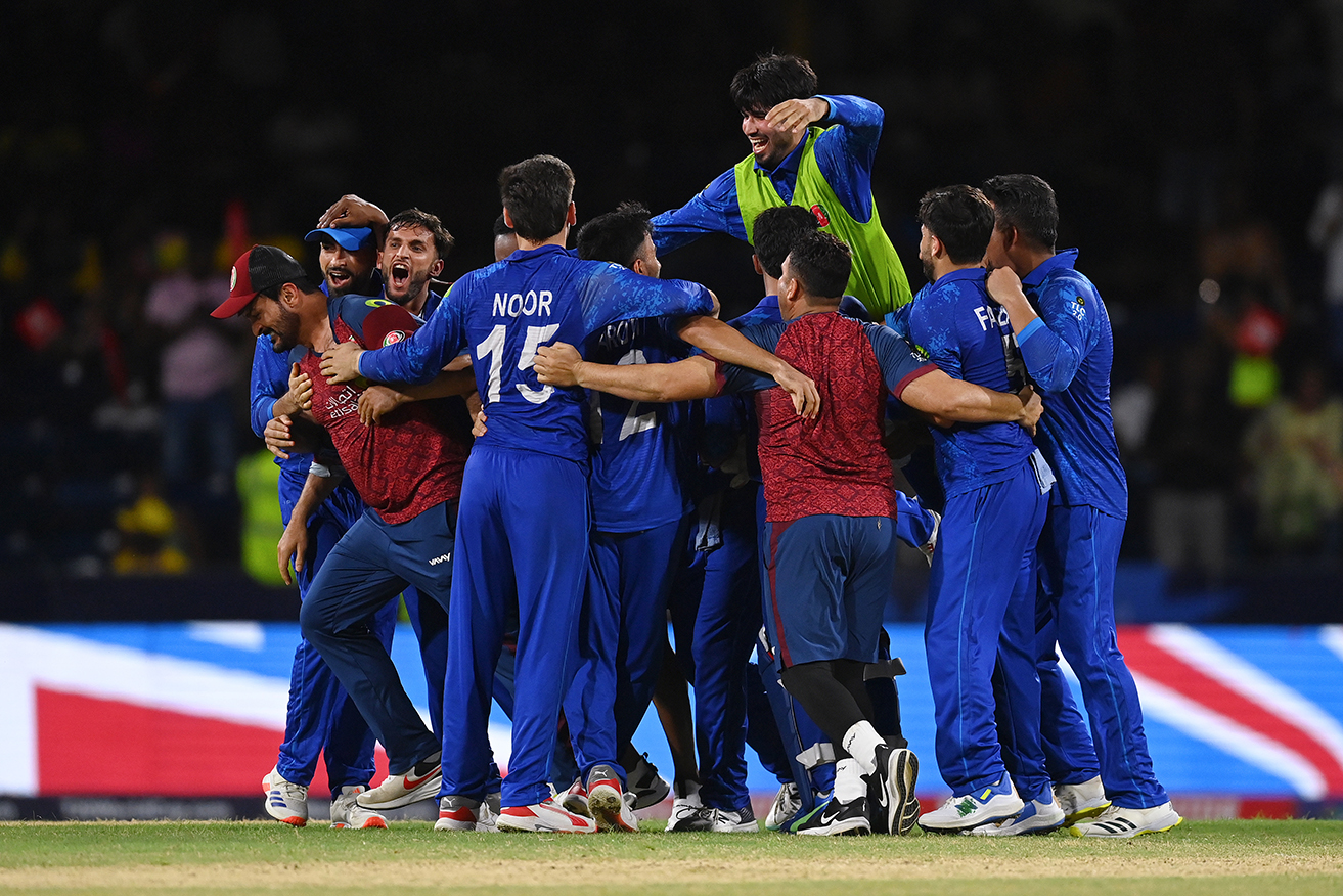 Jubilant Afghanistan players celebrate beating Australia in St Vincent on Sunday.