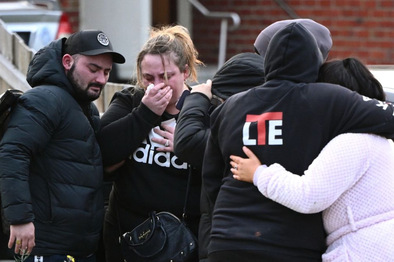 Family and friends gather at the Melbourne home where four bodies were found.