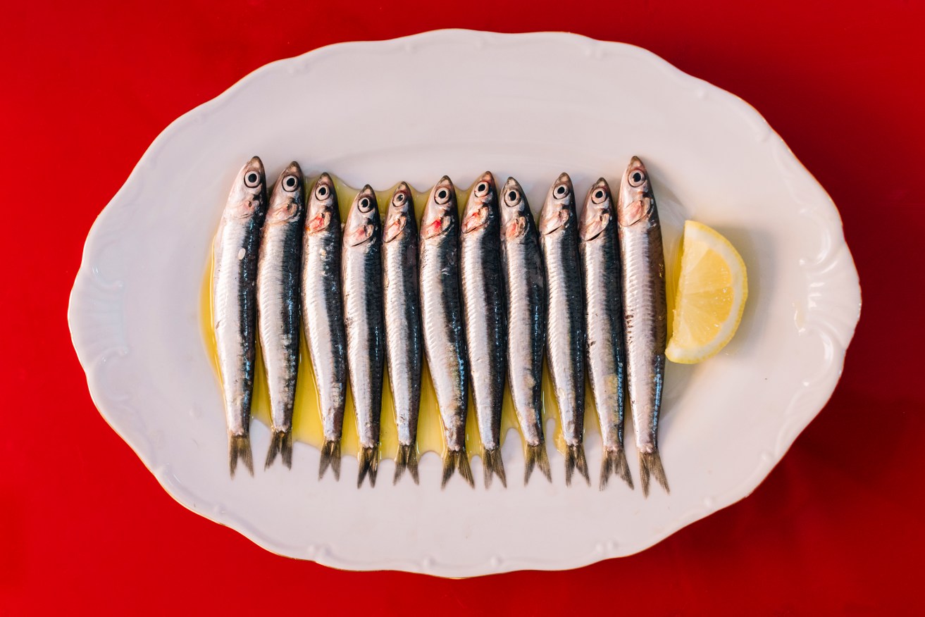 Bones  and all. Whole small fish deliver more nutrition and protects against cancer.  