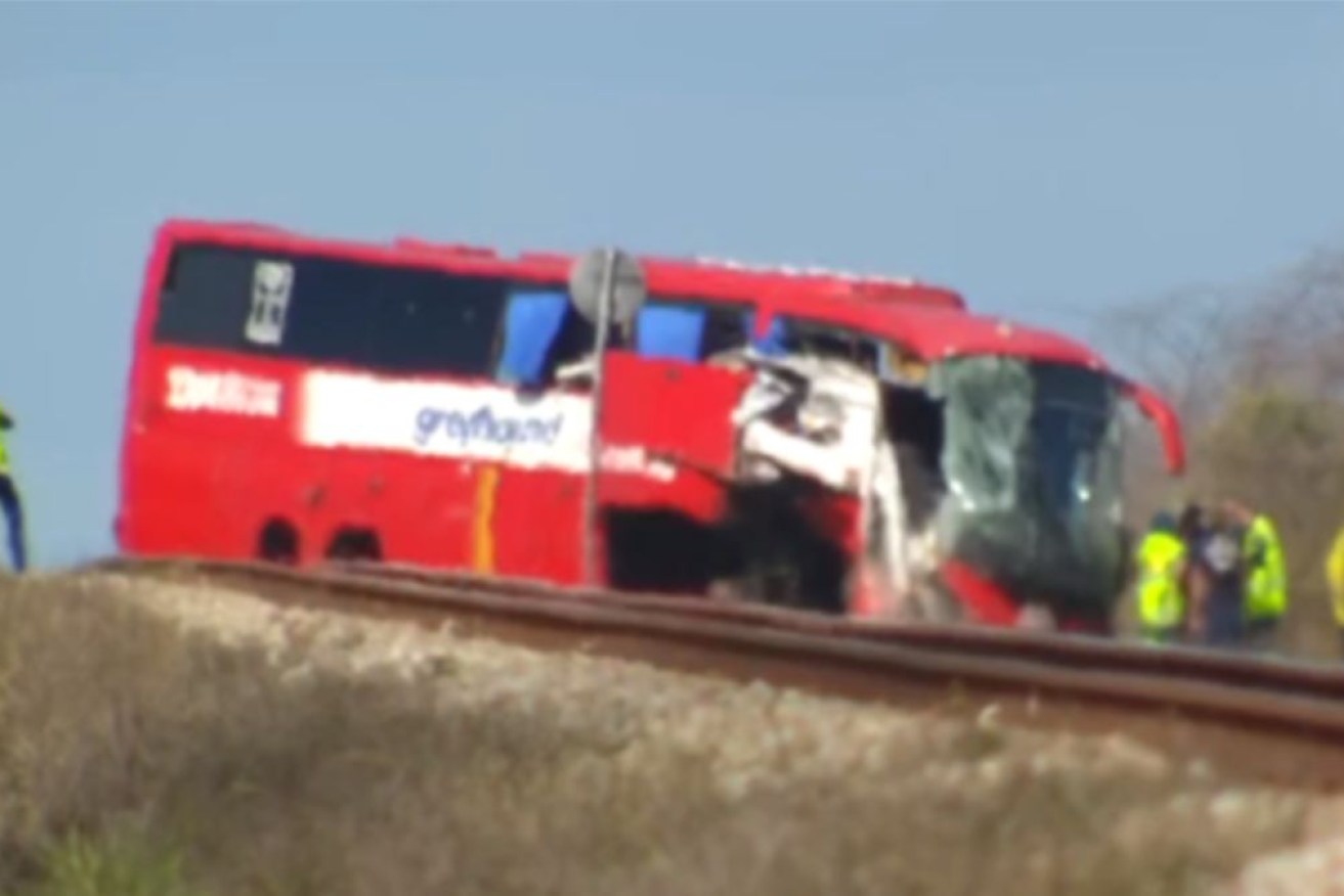 The Greyhound bus came to a stop on railway tracks adjacent to the Bruce Highway.
