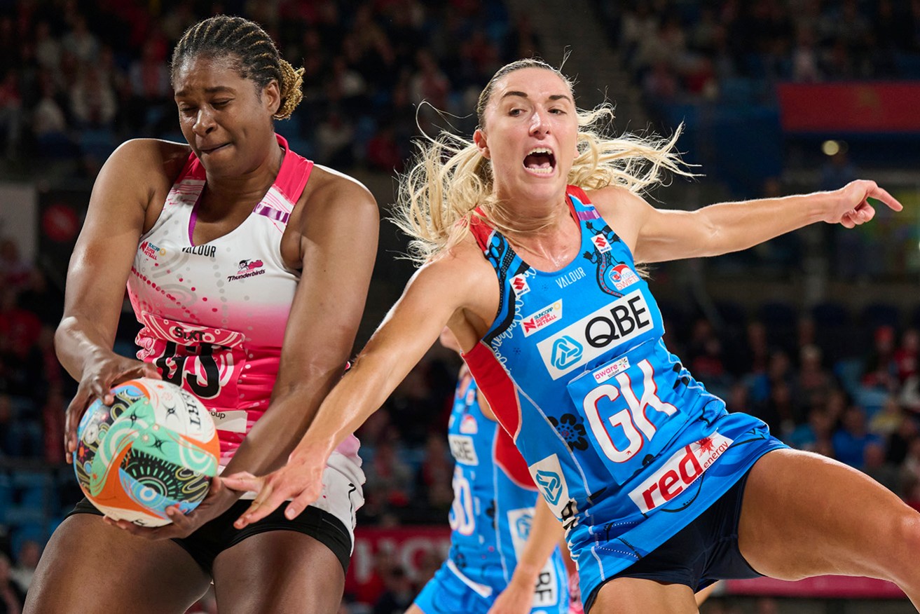 Adelaide’s Romelda Aiken-George and NSW Swifts’ Sarah Klau vie for possession in Sunday’s Super Netball match in Sydney.