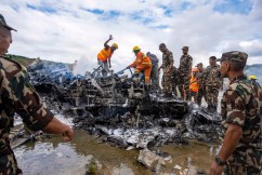 Plane slips off runway at Nepal airport, killing 18