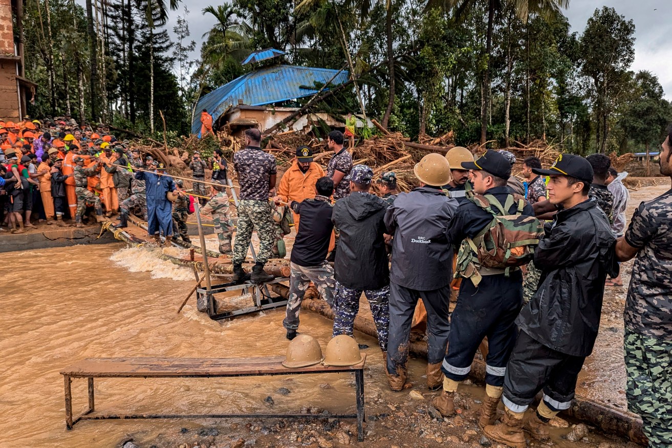 Indian soldiers work to rescue people after heavy rain triggered deadly landslides.